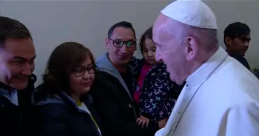 Pope Francis and the refugees from Lesbos unveiling the cross of migrants: